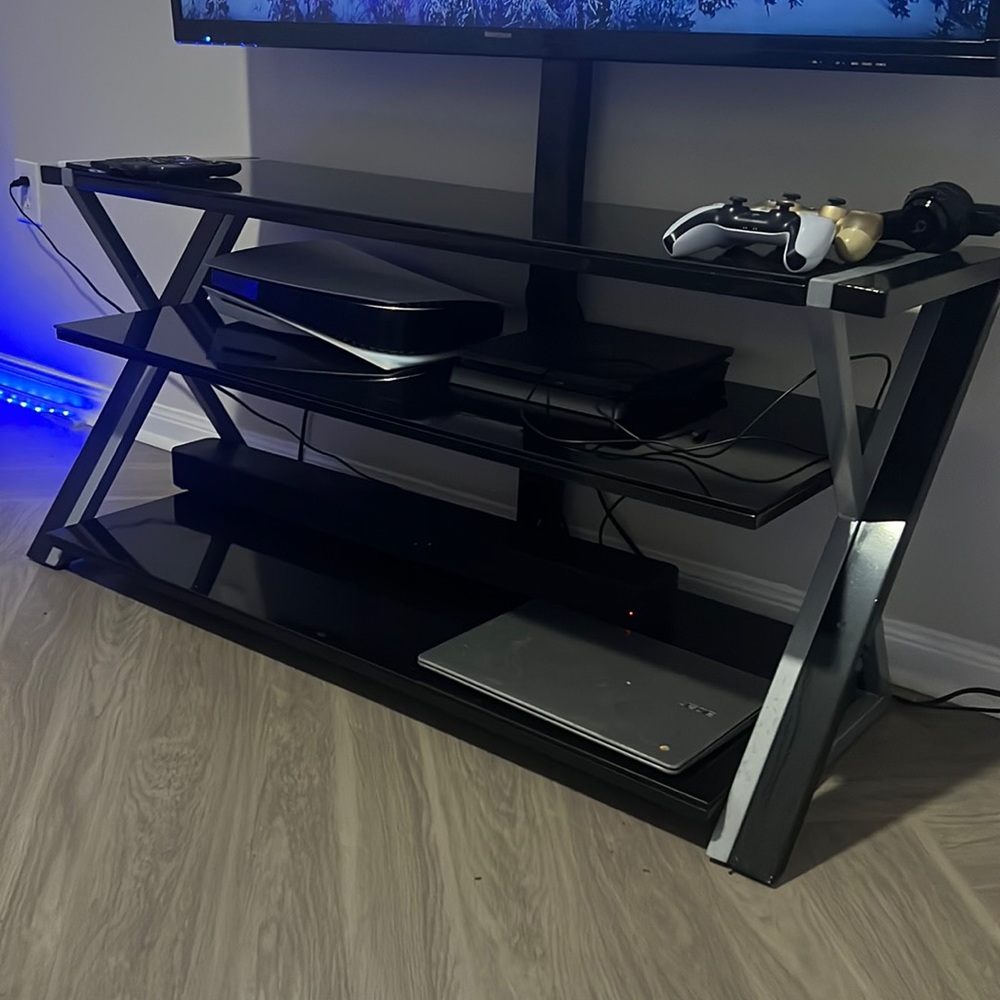 Stainless steel black rotational tv stand with a three level storage